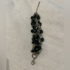 Green and gold chain and bead bracelet.